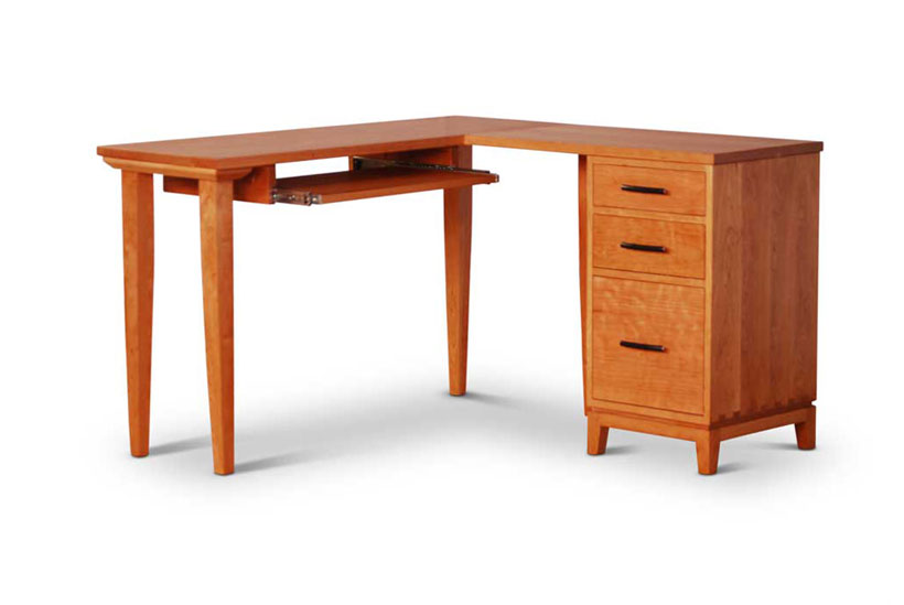 Corner Desk in cherry with drawer pedestal on right containing two drawers and one file cabinet, keyboard shelf on left
